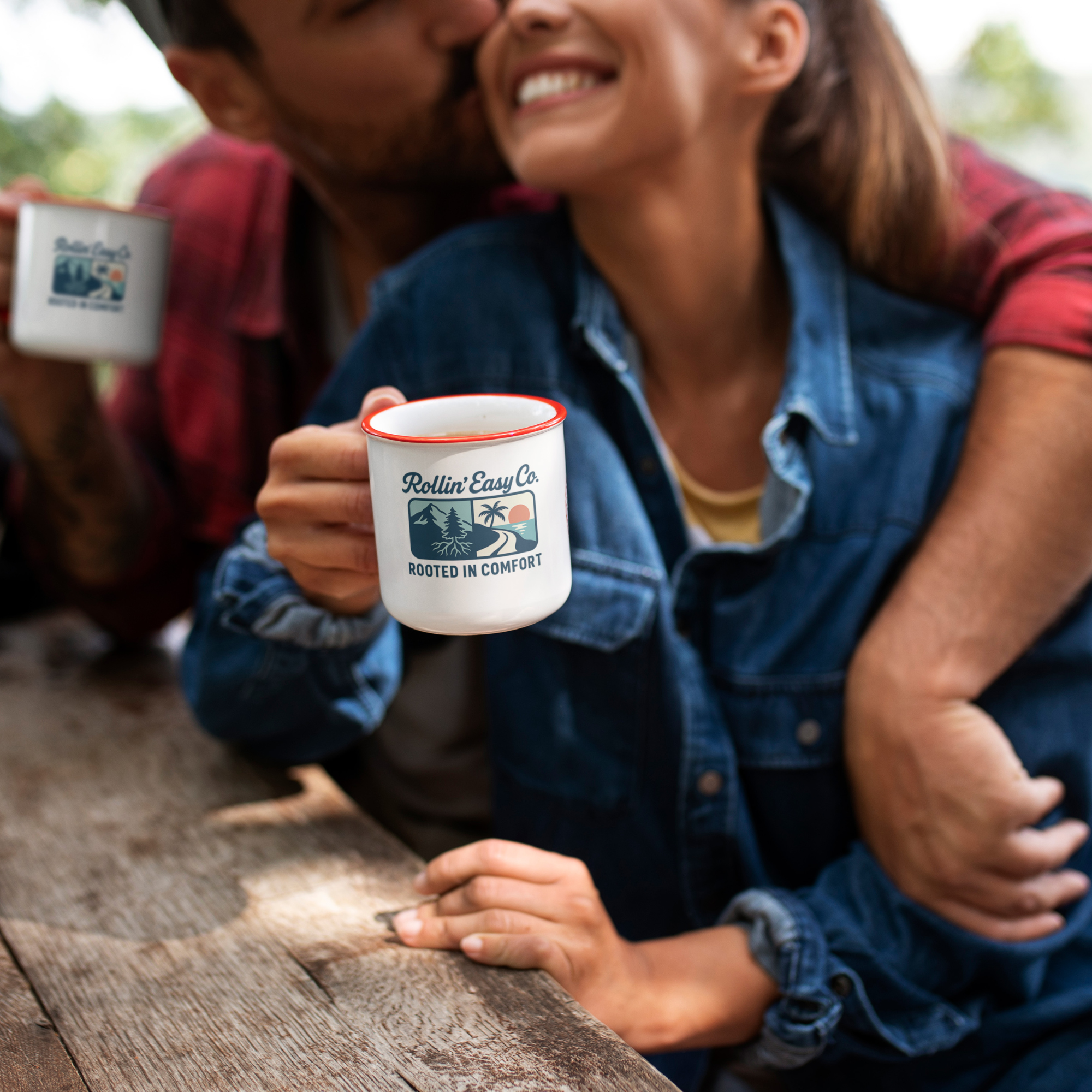 Person holding a mug with a scenic design outdoors
